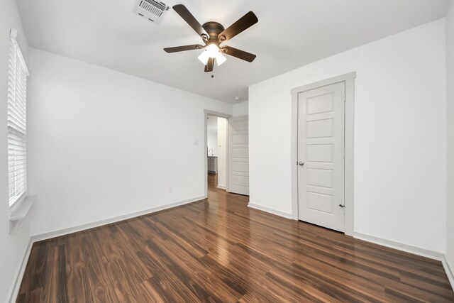 2906 Chase Cross Ln, Houston, TX 77047 - unfurnished bedroom featuring dark wood-style flooring, baseboards, and a ceiling fan