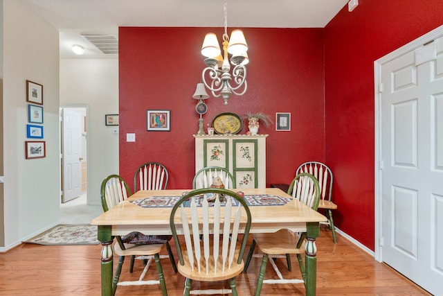 225 Mesa Vw, Montgomery, TX 77316 - dining area with a chandelier, light wood-style flooring, and baseboards