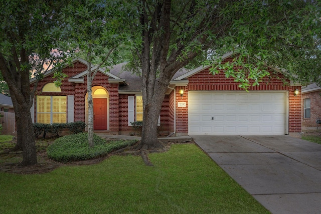 225 Mesa Vw, Montgomery, TX 77316 - view of front of home featuring driveway, brick siding, an attached garage, and a front yard