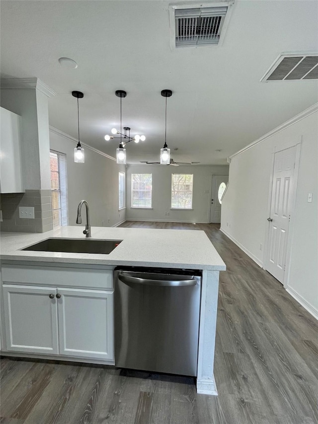 kitchen with ornamental molding, visible vents, stainless steel dishwasher, pendant lighting, and a sink