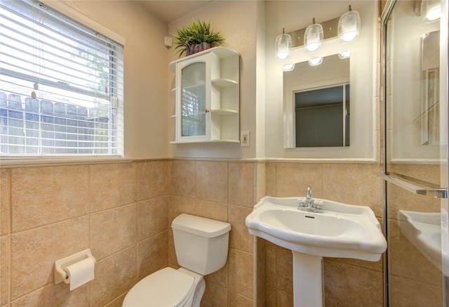 9534 Meadowglen Ln, Houston, TX 77063 - bathroom featuring a wainscoted wall, tile walls, and toilet