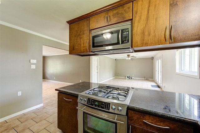 9534 Meadowglen Ln, Houston, TX 77063 - kitchen with open floor plan, crown molding, light tile patterned flooring, and stainless steel appliances