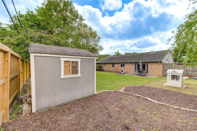 9534 Meadowglen Ln, Houston, TX 77063 - view of yard featuring a patio, a fenced backyard, an outdoor structure, and a storage unit