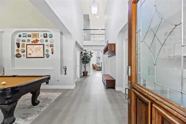 18023 Channel Hill Dr, Cypress, TX 77433 - foyer entrance featuring a high ceiling, light wood-type flooring, baseboards, arched walkways, and billiards