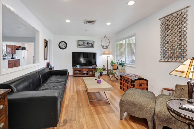 living room with light wood-style floors and recessed lighting