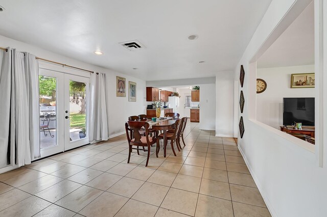 dining area featuring french doors, light tile patterned floors, recessed lighting, and baseboards
