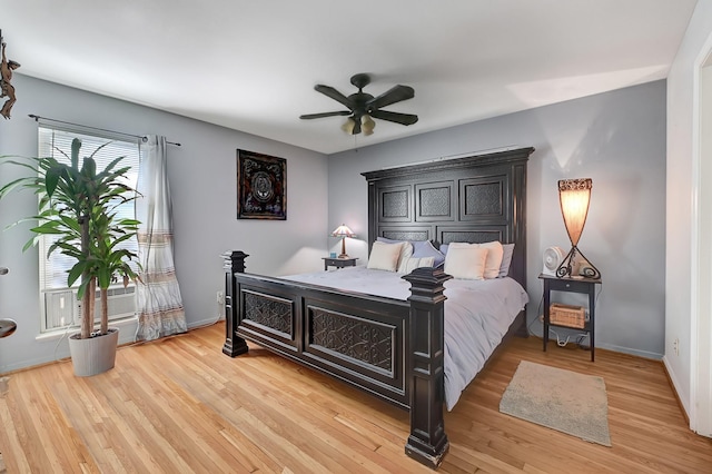 bedroom featuring light wood-style floors, baseboards, and a ceiling fan