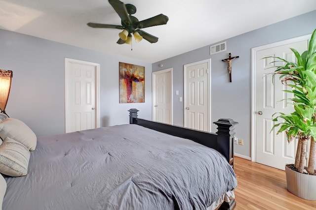 bedroom with light wood-style floors and a ceiling fan