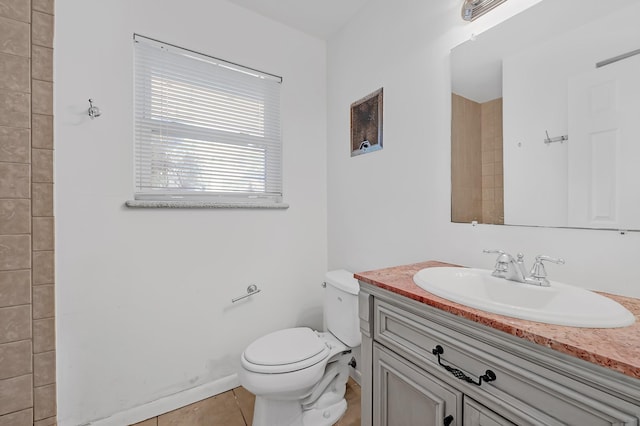 bathroom featuring toilet, vanity, and tile patterned floors