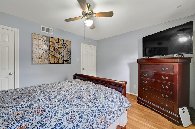 bedroom with light wood-style flooring and a ceiling fan