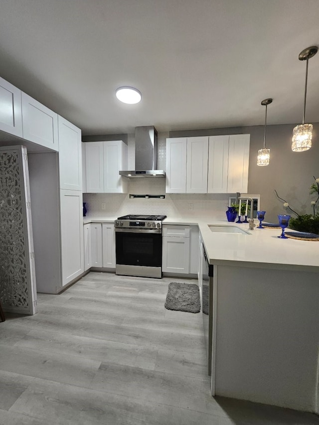 3241 Reeves St, Houston, TX 77004 - kitchen with wall chimney range hood, stainless steel appliances, a sink, and white cabinetry