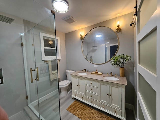 3241 Reeves St, Houston, TX 77004 - full bath with a stall shower, double vanity, toilet, and wood finished floors