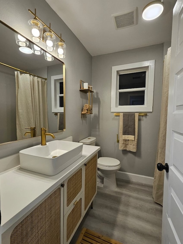 3241 Reeves St, Houston, TX 77004 - full bathroom featuring wood finished floors, baseboards, vanity, and toilet