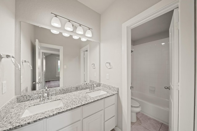 full bath featuring toilet, tile patterned flooring, a sink, and double vanity