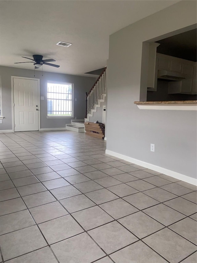 7307 Adelbert St, Houston, TX 77093 - unfurnished living room featuring light tile patterned flooring, stairway, and ceiling fan