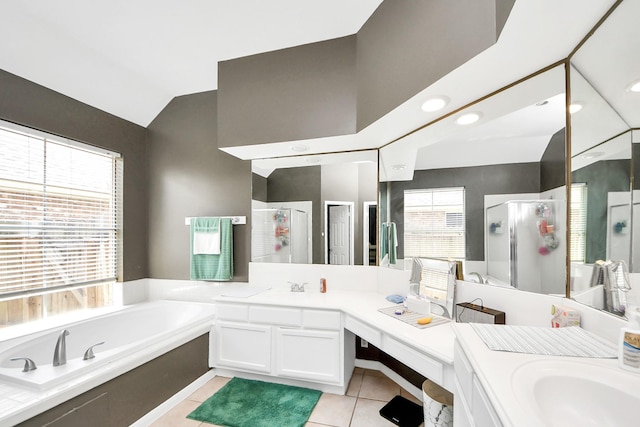 bathroom featuring a shower stall, tile patterned flooring, a bath, lofted ceiling, and vanity