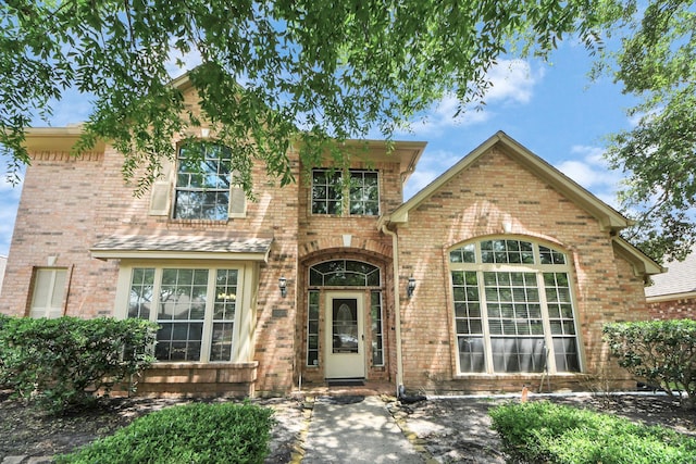traditional-style house featuring brick siding
