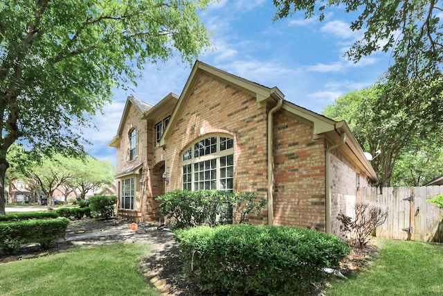 view of property exterior featuring brick siding