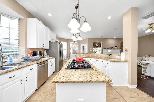 kitchen featuring stainless steel appliances, a chandelier, healthy amount of natural light, a kitchen island, and recessed lighting