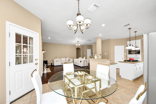 dining room with light tile patterned floors, a chandelier, a ceiling fan, and recessed lighting