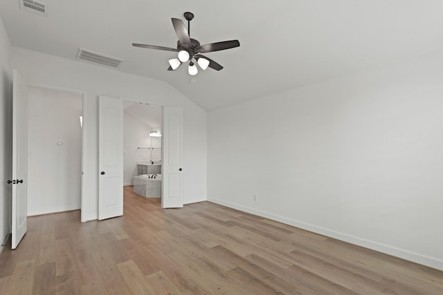 14514 Hueco Mountain Dr, Cypress, TX 77429 - unfurnished bedroom with light wood-style floors, lofted ceiling, baseboards, connected bathroom, and ceiling fan