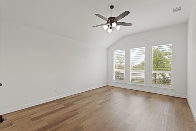 14514 Hueco Mountain Dr, Cypress, TX 77429 - empty room with wood finished floors, vaulted ceiling, baseboards, and a ceiling fan