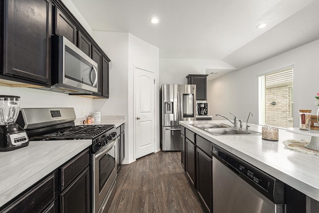 22435 Forest Gorge Ln, Spring, TX 77373 - kitchen featuring appliances with stainless steel finishes, a sink, light countertops, dark wood finished floors, and recessed lighting
