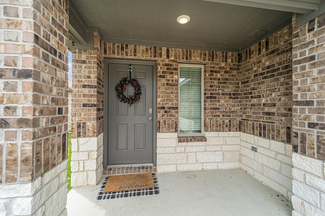 22435 Forest Gorge Ln, Spring, TX 77373 - view of exterior entry with a porch and brick siding