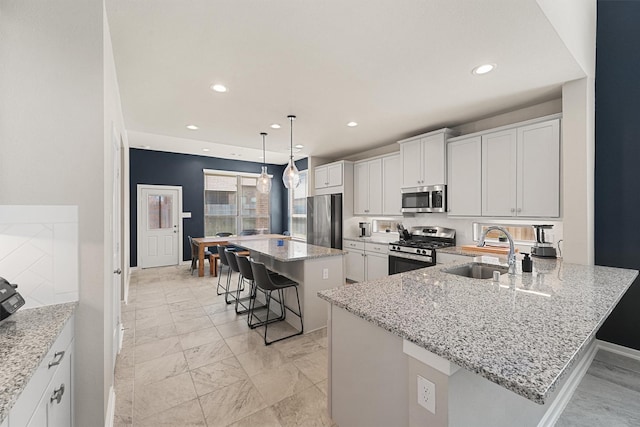 908 Newport Creek Dr, Katy, TX 77493 - kitchen with a kitchen breakfast bar, recessed lighting, marble finish floor, a sink, and stainless steel appliances