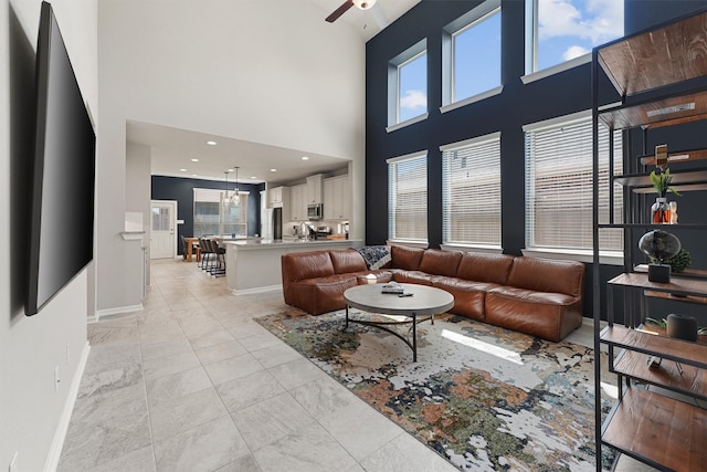 908 Newport Creek Dr, Katy, TX 77493 - living room featuring a high ceiling, baseboards, and ceiling fan