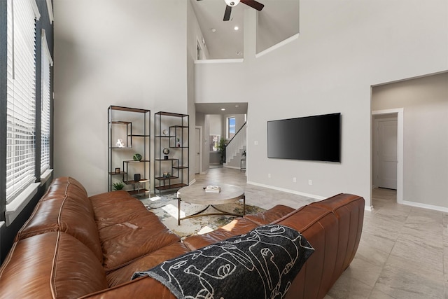 908 Newport Creek Dr, Katy, TX 77493 - living room with a healthy amount of sunlight, stairs, baseboards, and ceiling fan