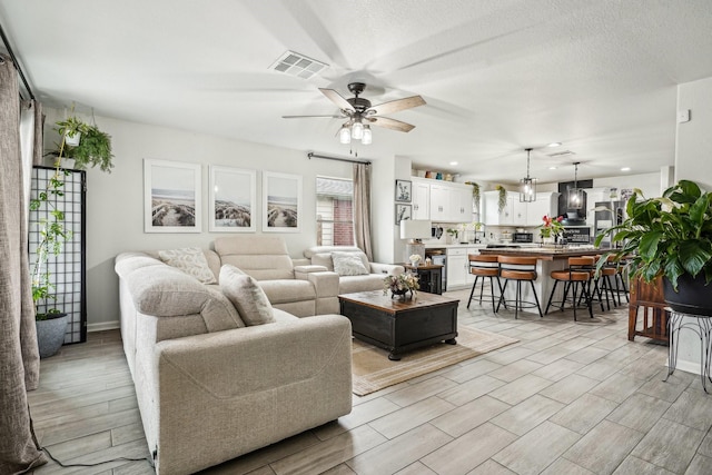 8010 Clover Leaf Dr, Rosenberg, TX 77469 - living area featuring visible vents and a ceiling fan