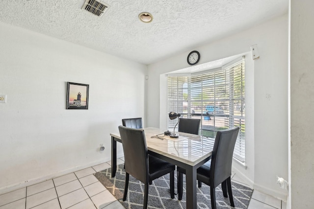 5347 Inwood Dr, Katy, TX 77493 - dining area featuring visible vents, baseboards, light tile patterned floors, and a textured ceiling
