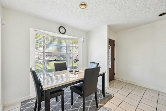 5347 Inwood Dr, Katy, TX 77493 - dining room with light tile patterned floors, a textured ceiling, and baseboards