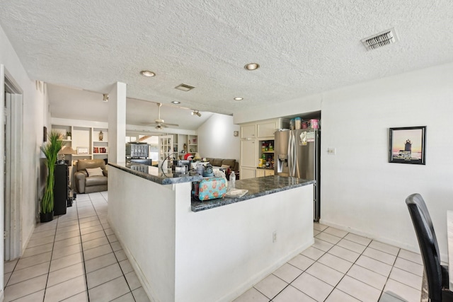 5347 Inwood Dr, Katy, TX 77493 - kitchen with open floor plan, light tile patterned floors, visible vents, and stainless steel refrigerator with ice dispenser