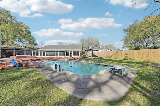 5347 Inwood Dr, Katy, TX 77493 - view of swimming pool with a sunroom, a fenced backyard, a fenced in pool, and a lawn
