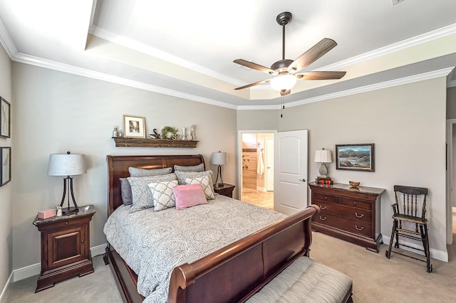 bedroom featuring a tray ceiling, light colored carpet, baseboards, and ornamental molding