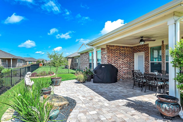 view of patio / terrace with outdoor dining area, a grill, fence, and ceiling fan