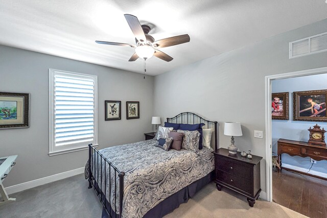 bedroom with visible vents, baseboards, ceiling fan, and carpet floors