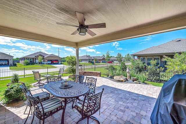 view of patio with a residential view, grilling area, outdoor dining area, a fenced backyard, and ceiling fan