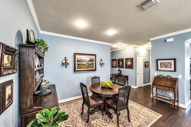 dining space with visible vents, baseboards, dark wood-style flooring, a textured ceiling, and crown molding