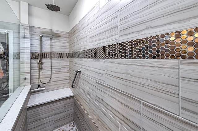 full bath featuring a tile shower