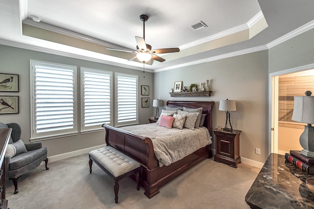 bedroom featuring baseboards, carpet flooring, crown molding, visible vents, and a raised ceiling