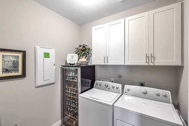 laundry room featuring cabinet space, washer and clothes dryer, and electric panel