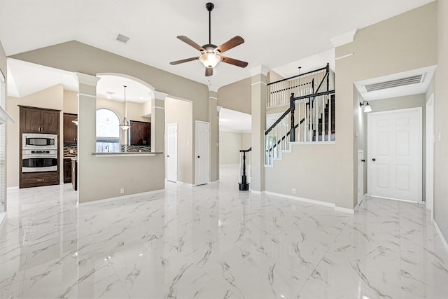 unfurnished living room with visible vents, a ceiling fan, marble finish floor, and ornate columns