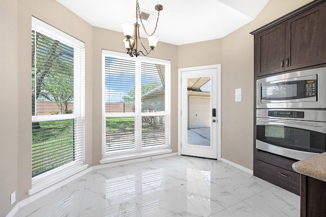 kitchen featuring appliances with stainless steel finishes, marble finish floor, a notable chandelier, and dark brown cabinets