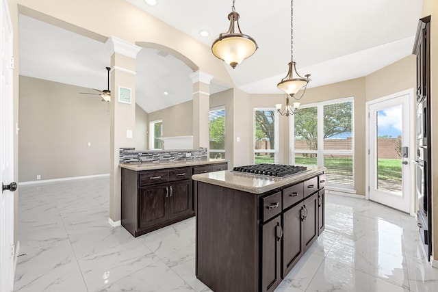 kitchen featuring ceiling fan, ornate columns, vaulted ceiling, marble finish floor, and baseboards