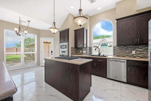 kitchen with a sink, appliances with stainless steel finishes, dark brown cabinets, marble finish floor, and a kitchen island