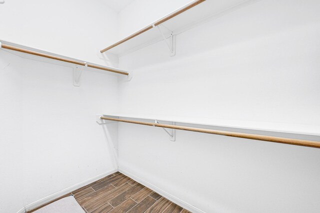 walk in closet featuring wood finish floors