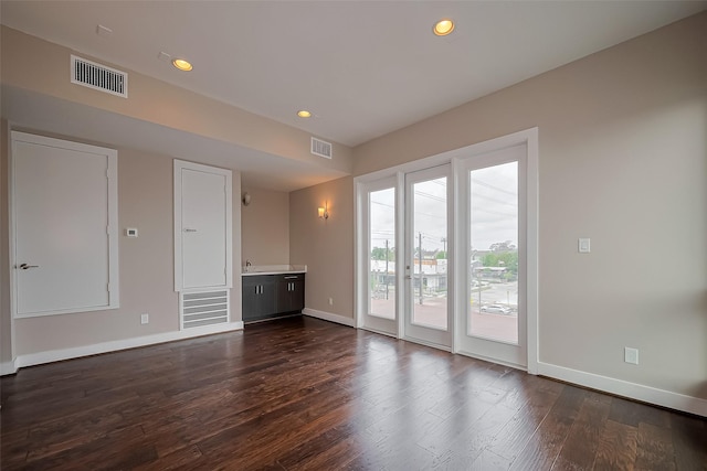 1305 Laird St, Houston, TX 77008 - unfurnished living room with baseboards, dark wood finished floors, and recessed lighting